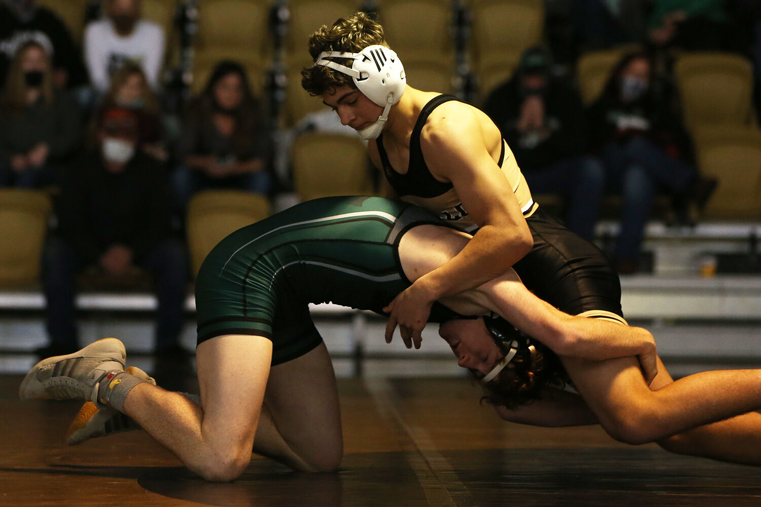 Hazen Camino pushes forward over his Green River opponent Brett Stanton